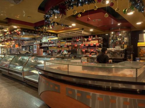 a person standing at the counter of a restaurant at Hotel El Arroyo in Caracas