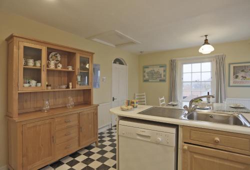 a kitchen with a sink and a counter top at 10a East Cliff in Southwold