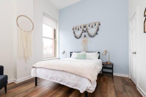 a white bedroom with a large bed and a window at Serenity & Ultimate Airjet Relaxation Retreat in Cleveland