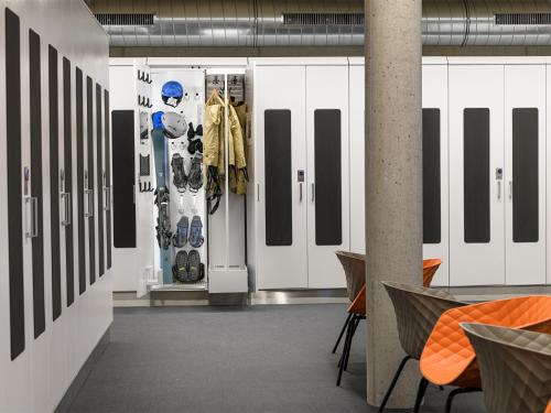a room with white doors and shoes on display at Alpinresort ValSaa - Sport & Spa in Saalbach Hinterglemm