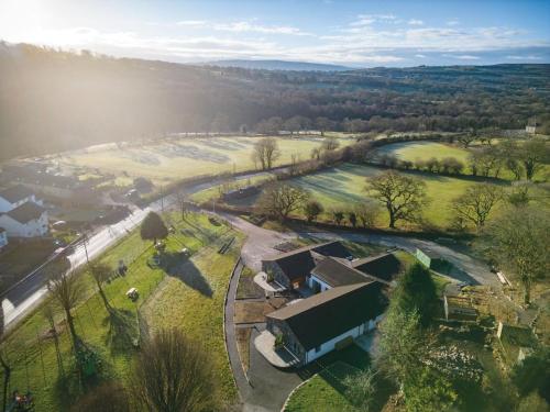 an aerial view of a farm with a building and a field at Suite 15 - Sleeping Giant Hotel - Pen Y Cae Inn in Brecon