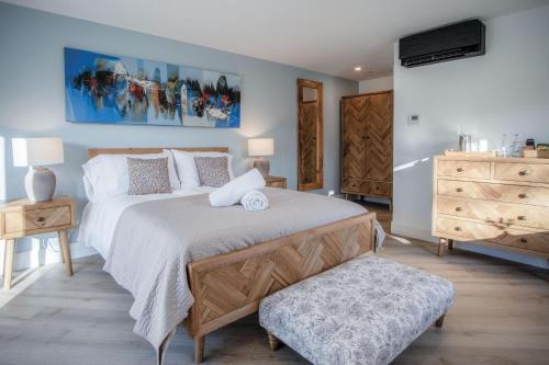 a bedroom with a large bed and a dresser at Suite 9 - Sleeping Giant Hotel - Pen Y Cae Inn in Brecon