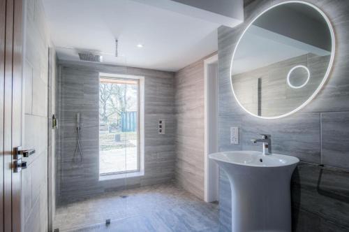 a bathroom with a sink and a mirror at Suite 10 - Sleeping Giant Hotel - Pen Y Cae Inn in Brecon