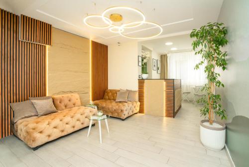 a living room with a couch and a table at 7 Hills Rooms in Podgorica