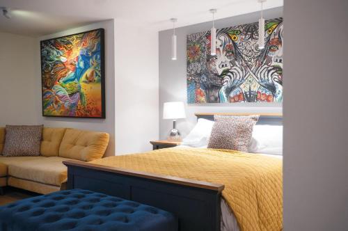 a bedroom with a bed and a couch at Suite 14 - Sleeping Giant Hotel - Pen Y Cae Inn in Brecon