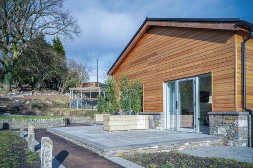 a wooden house with a large glass door at Suite 11 - Sleeping Giant Hotel - Pen Y Cae Inn in Brecon