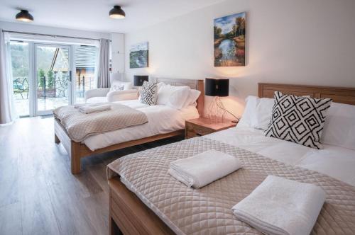 a bedroom with two beds and a living room at Suite 3 - Sleeping Giant Hotel - Pen Y Cae Inn in Brecon