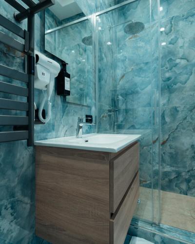 a bathroom with a sink and a shower at B&B Mirò Luxury aeroporto capodichino Napoli in Naples