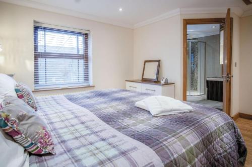 a bedroom with a large bed and a window at Oak Lodge - The Sleeping Giant - Pen Y Cae Inn in Brecon