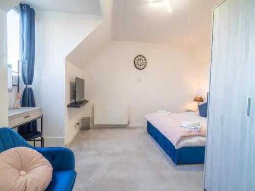 um quarto com uma cama e um relógio na parede em Pass the Keys Elegant Home with free Parking em Nottingham