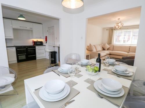 a kitchen and living room with a table and chairs at Serendipity in Freshwater