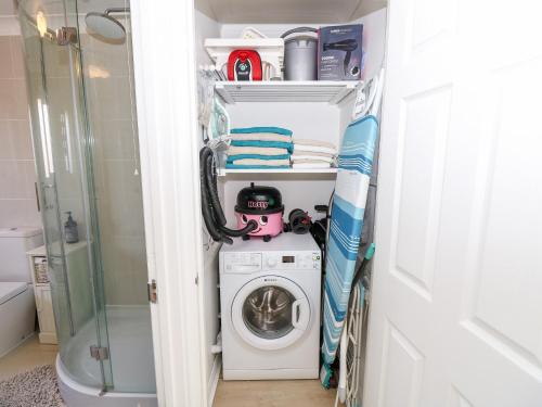 a laundry room with a washer and dryer at Serendipity in Freshwater