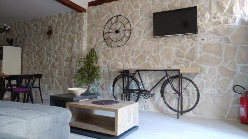 una sala de estar con una bicicleta en una pared de piedra en Apartment Tia Vis, en Vis