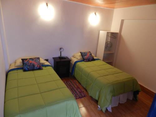 Ein Bett oder Betten in einem Zimmer der Unterkunft Hostal Siete Colores