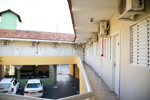 an empty hallway of a building with cars parked at Hotel Casa Nova in Várzea Grande