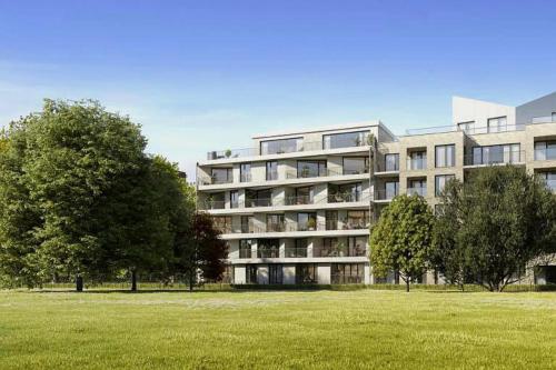 a large building with a field in front of it at Be London - The London Residences in London