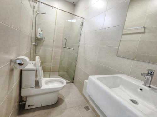 a white bathroom with a toilet and a sink at Harmony suites 1, 3-5 pax, Jelutong Georgetown Penang in Jelutong