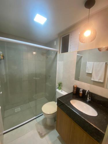 a bathroom with a shower and a toilet and a sink at Meireles Compact Apartamento 500m da praia in Fortaleza