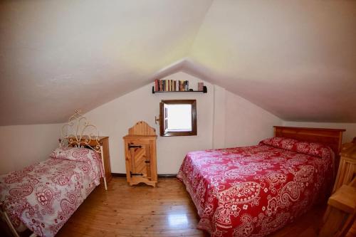 a attic bedroom with two beds and a window at Casa Lia in Cascine