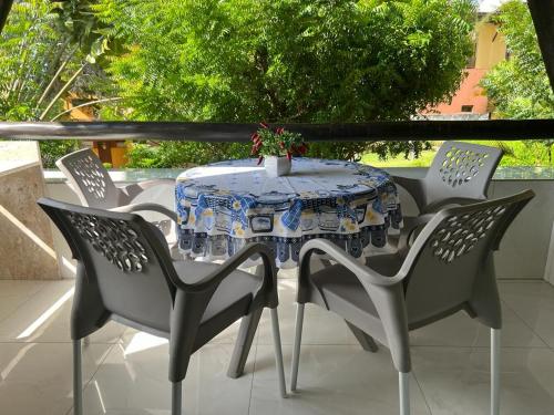 une table et des chaises assises sur une terrasse dans l'établissement Winterville Gravatá Lazer e descanso!, à Gravatá