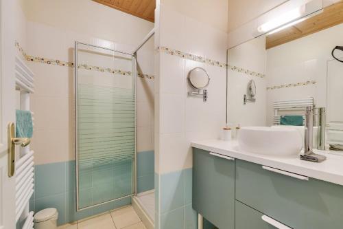 a bathroom with a sink and a shower at Maison moderne 2 chambres avec piscine commune in Les Sables-d'Olonne