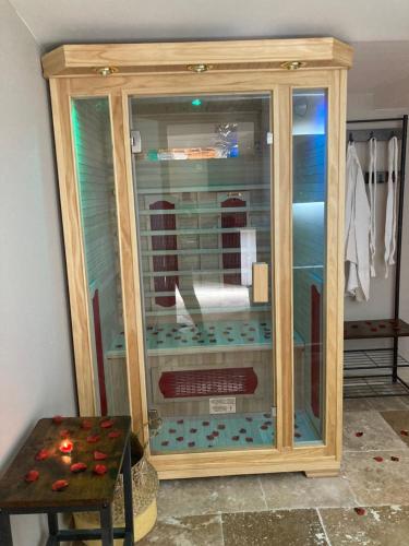 a wooden display case in a room with a table at La nuit glamour in Herblay