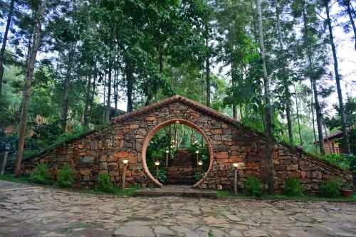 a stone building with an arch in the middle at Sereno Barn Eco Stay Chikmagalur in Chikmagalūr