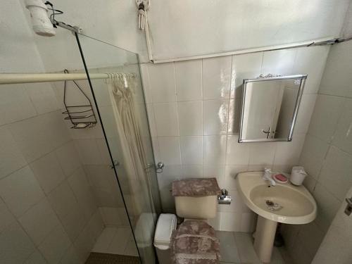a bathroom with a shower and a sink and a toilet at Casa La Galería in Asuncion