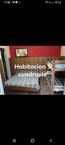 a poster of a room with two bunk beds at Hotel Andrea in Mar del Plata