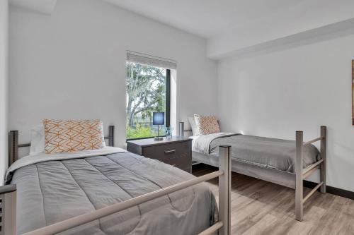 a bedroom with two beds and a window at The Well 210 in Zephyrhills