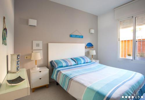 biała sypialnia z łóżkiem i oknem w obiekcie VH CostaBlanca - SANDRINE w mieście Cumbre del Sol
