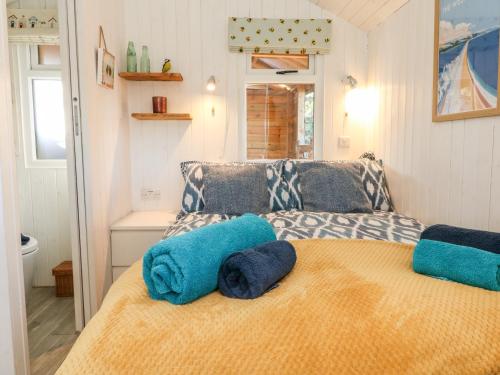 a bedroom with a bed with blue towels on it at Langdale Lodge in Okehampton