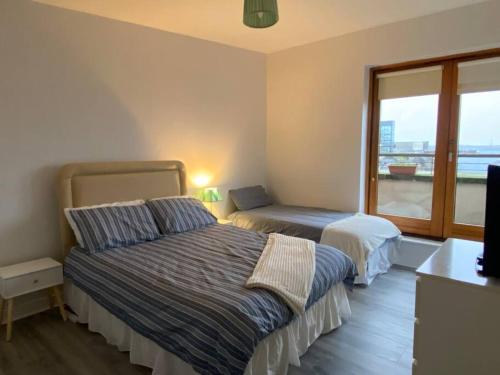 a bedroom with a bed and a window at Vera’s Penthouse in Wexford