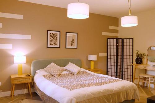 a bedroom with a bed with two lamps and two tables at Stunning Coach House in Largs