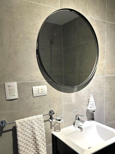 a bathroom with a sink and a mirror on the wall at Caleta View Marítimo in Puerto Madryn
