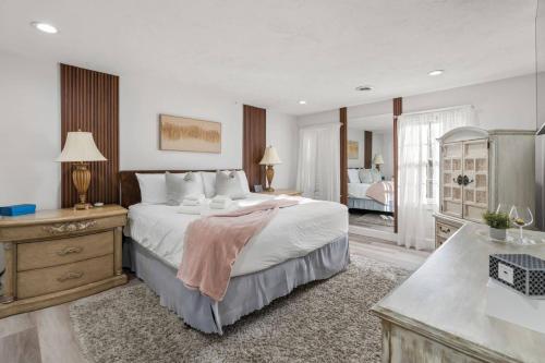 a large bedroom with a large bed and a bathroom at Barnstable Luxury Family Retreat with pool, fire pit and beach nearby in Barnstable