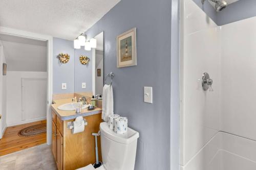 un baño con inodoro y lavabo en Homeport Harwich by the Lakes, en Harwich