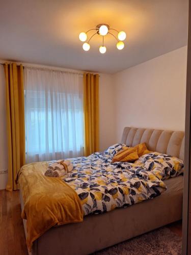a bed sitting in a bedroom with a window at Apartman Laguna in Zagreb