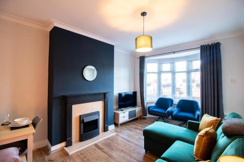 a living room with a couch and a fireplace at Charming Middlesbrough Home in Middlesbrough
