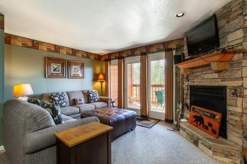 a living room with a couch and a fireplace at Papa Bears Hideaway Stunning Views CommunityPOOL in Pigeon Forge