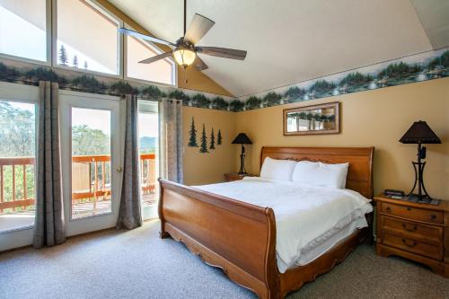 a bedroom with a bed and a ceiling fan at Papa Bears Hideaway Stunning Views CommunityPOOL in Pigeon Forge