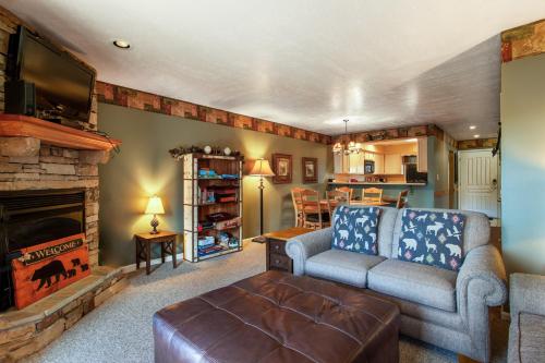 a living room with a couch and a fireplace at Papa Bears Hideaway Stunning Views CommunityPOOL in Pigeon Forge