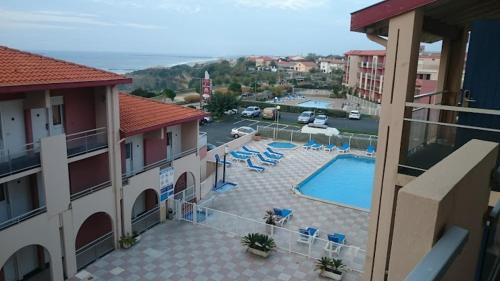 - une vue sur la piscine depuis le balcon de l'hôtel dans l'établissement Duplex vue Océan- Piscine-Plage à pied, à Anglet