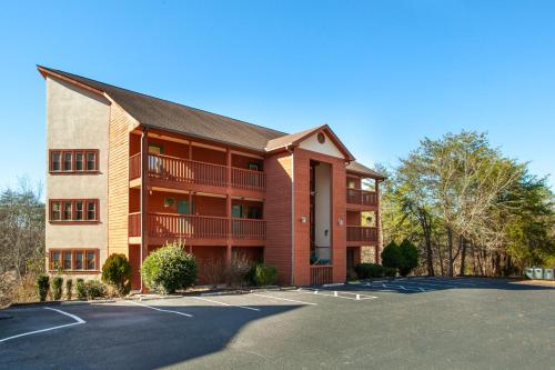 a building with a parking lot in front of it at Papa Bears Hideaway Stunning Views CommunityPOOL in Pigeon Forge