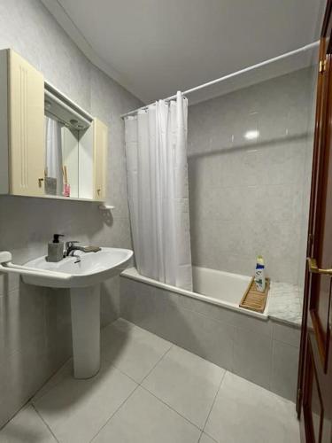 ein Bad mit einem Waschbecken und einer Dusche mit einer Badewanne in der Unterkunft Appartement vistahermosa in Vivero