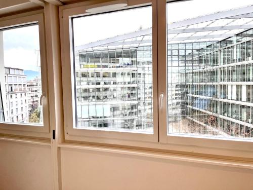 een raam met uitzicht op een gebouw bij Luxury Studio Near UN & Train Station in Genève