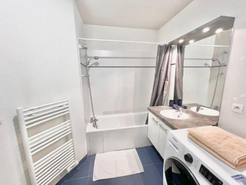 a white bathroom with a sink and a tub at Appartement T2 centre ville, balcon in Bonneville