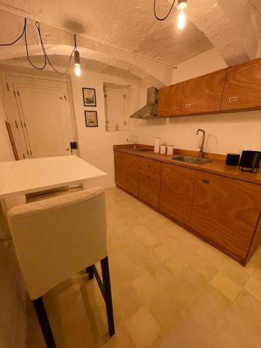 a large kitchen with a counter and a sink at La Bambina in Senglea