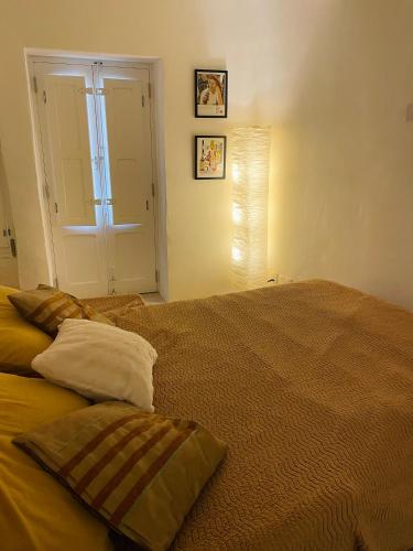 a bedroom with a bed with two pillows on it at La Bambina in Senglea