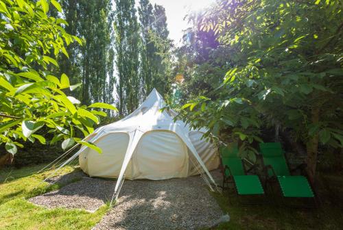 a white tent sitting in the shade of trees at Orion 4-Person Lotus Belle Tent in Ross on Wye